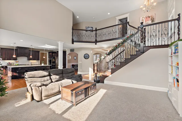 a kitchen with stainless steel appliances granite countertop a sink a stove and a wooden floors