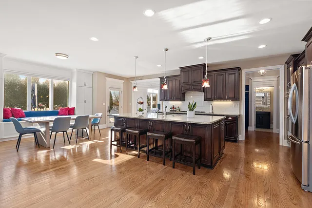a kitchen with stainless steel appliances granite countertop a sink and a refrigerator