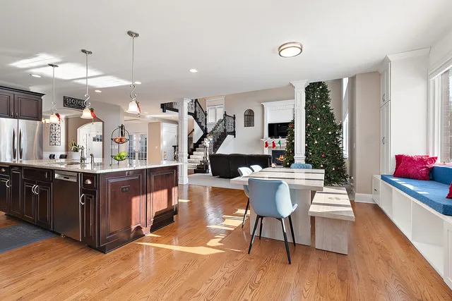 a view of a hallway with wooden floor and a living room