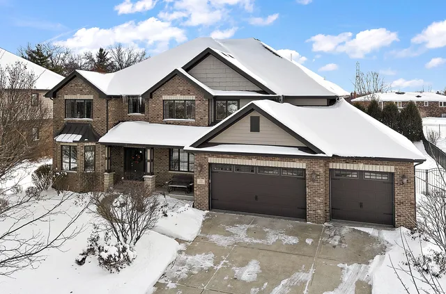 a view of a brick house with large windows