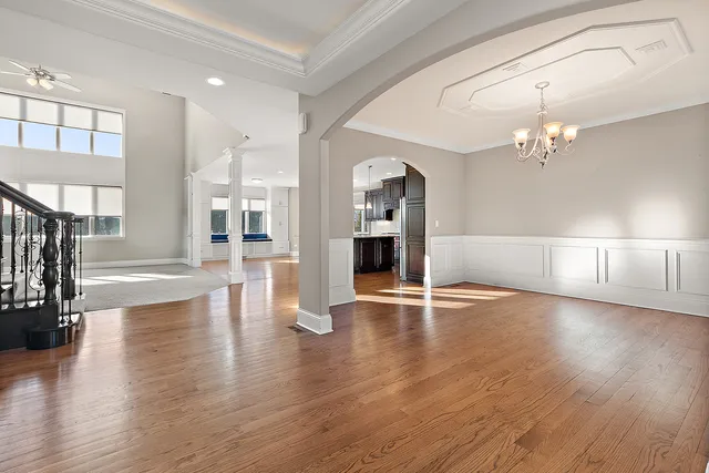 a large kitchen with stainless steel appliances kitchen island granite countertop a large counter top and wooden floors