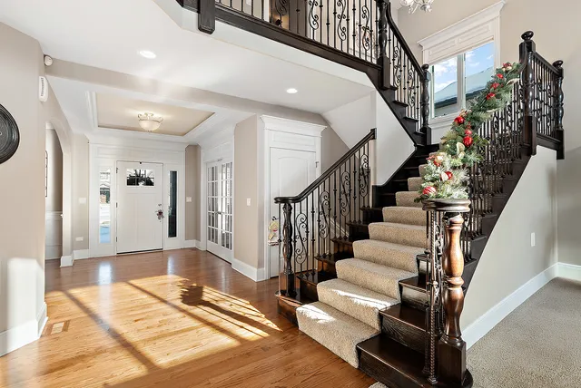 a living room with furniture a wooden floor and a large window