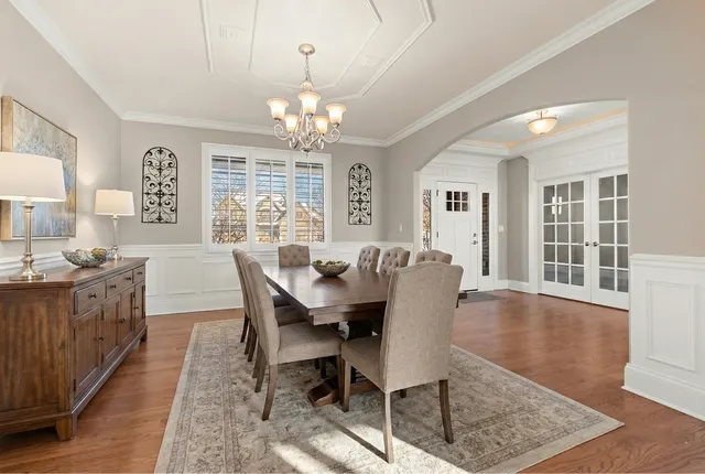 a large kitchen with stainless steel appliances kitchen island granite countertop a large counter top and a stove top oven with wooden floor