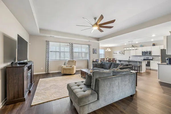 a view of a dining room with furniture wooden floor and chandelier