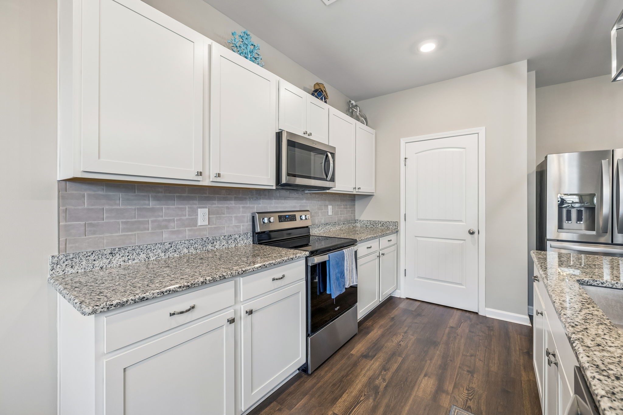 1426 Marigold Drive Spring Hill, TN 37174 - Photo 24 of 65 a kitchen with stainless steel appliances granite countertop a stove a sink and a microwave