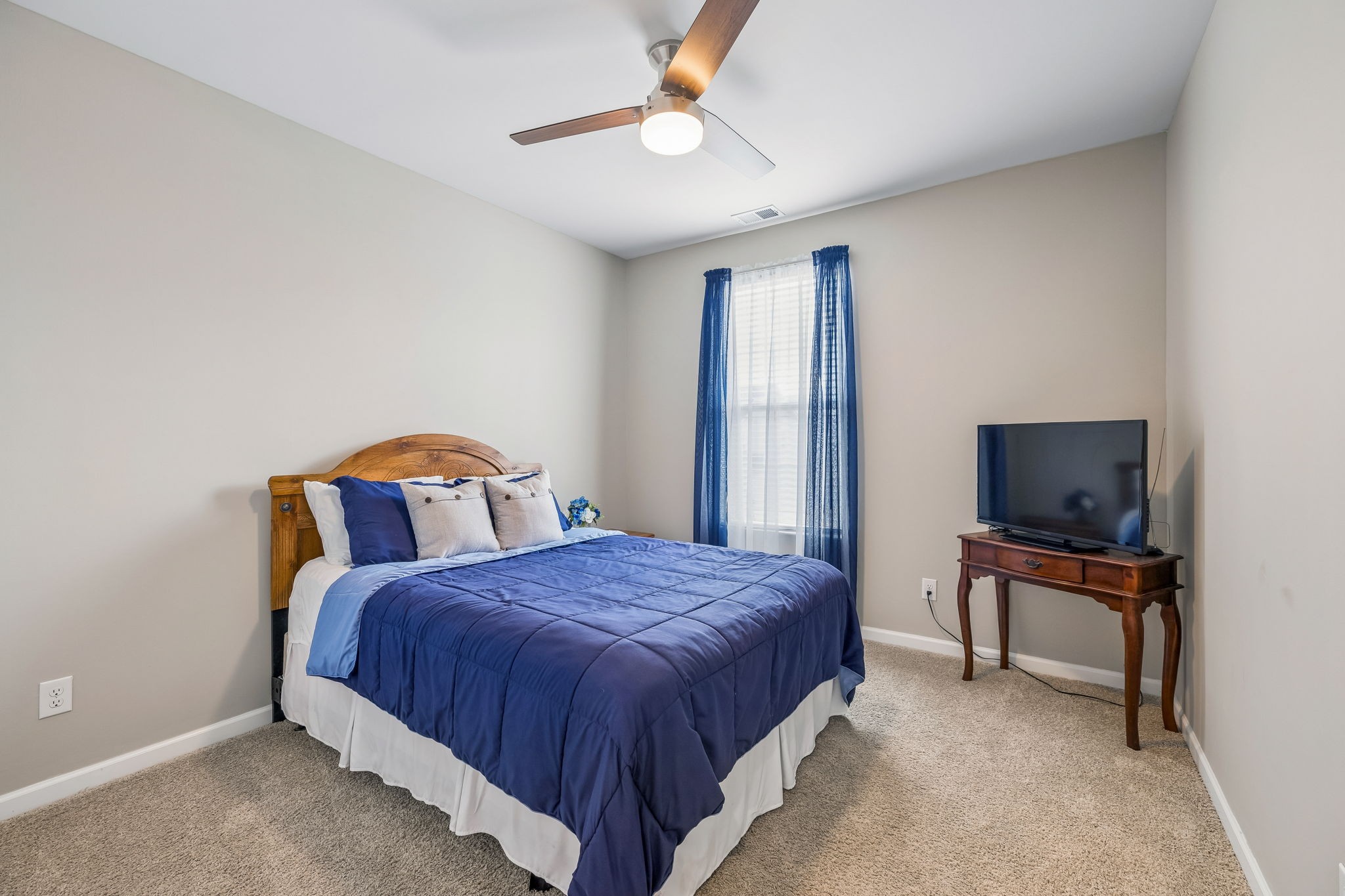 1426 Marigold Drive Spring Hill, TN 37174 - Photo 35 of 65 a bedroom with a bed and a flat screen tv