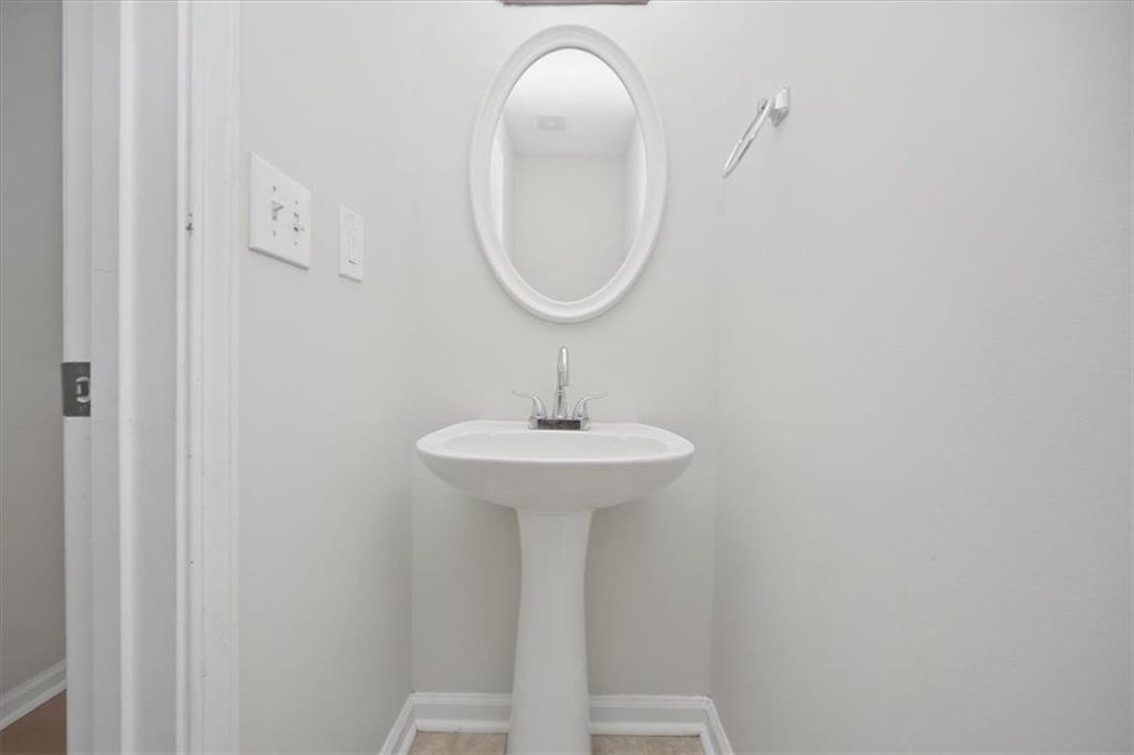 100 Wexford Way Covington, GA 30014 - Photo 16 of 37 a bathroom with a sink and a mirror