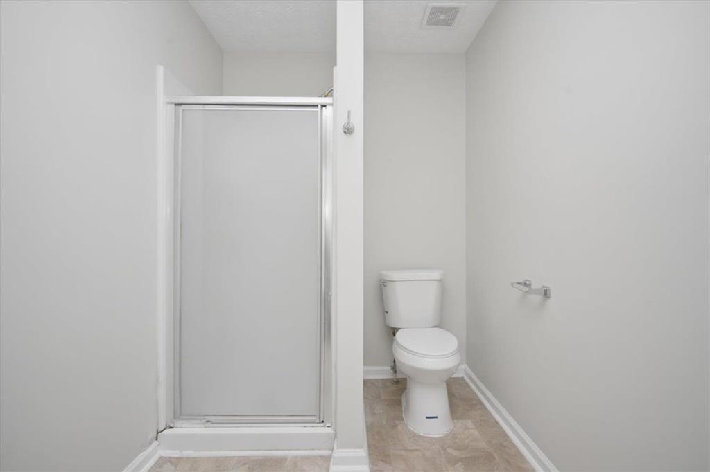 100 Wexford Way Covington, GA 30014 - Photo 24 of 37 a bathroom with a toilet and a shower