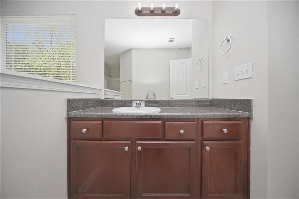100 Wexford Way Covington, GA 30014 - Photo 26 of 37 a bathroom with a granite countertop sink and a mirror