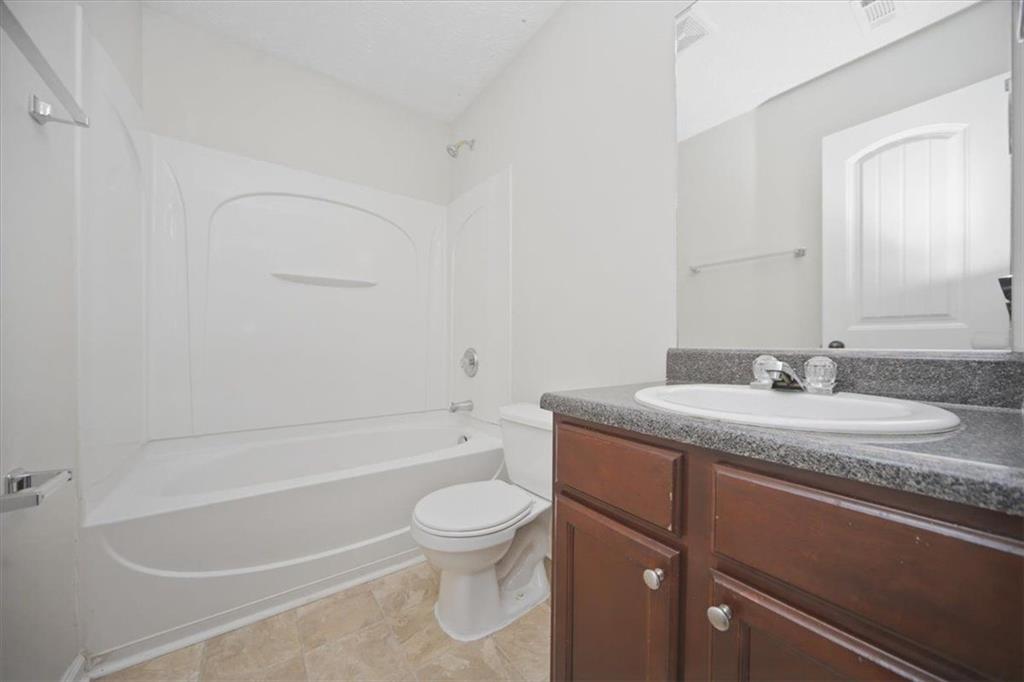 100 Wexford Way Covington, GA 30014 - Photo 27 of 37 a bathroom with a granite countertop sink toilet and shower