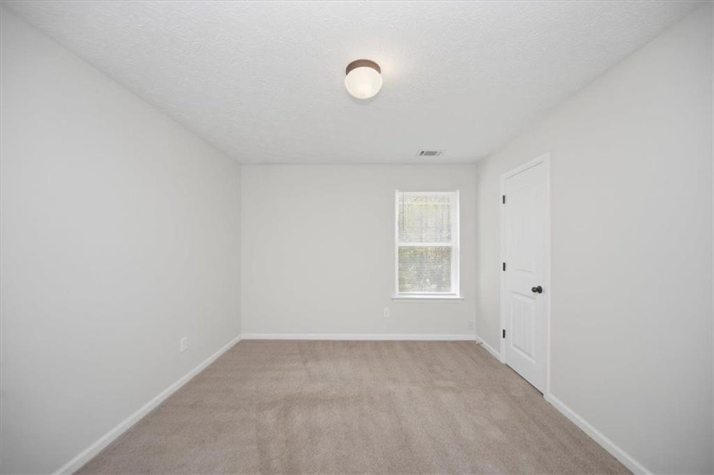 100 Wexford Way Covington, GA 30014 - Photo 28 of 37 a view of empty room with windows