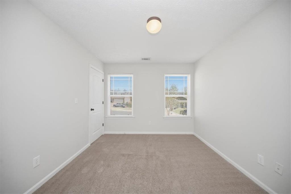 100 Wexford Way Covington, GA 30014 - Photo 32 of 37 an empty room with windows