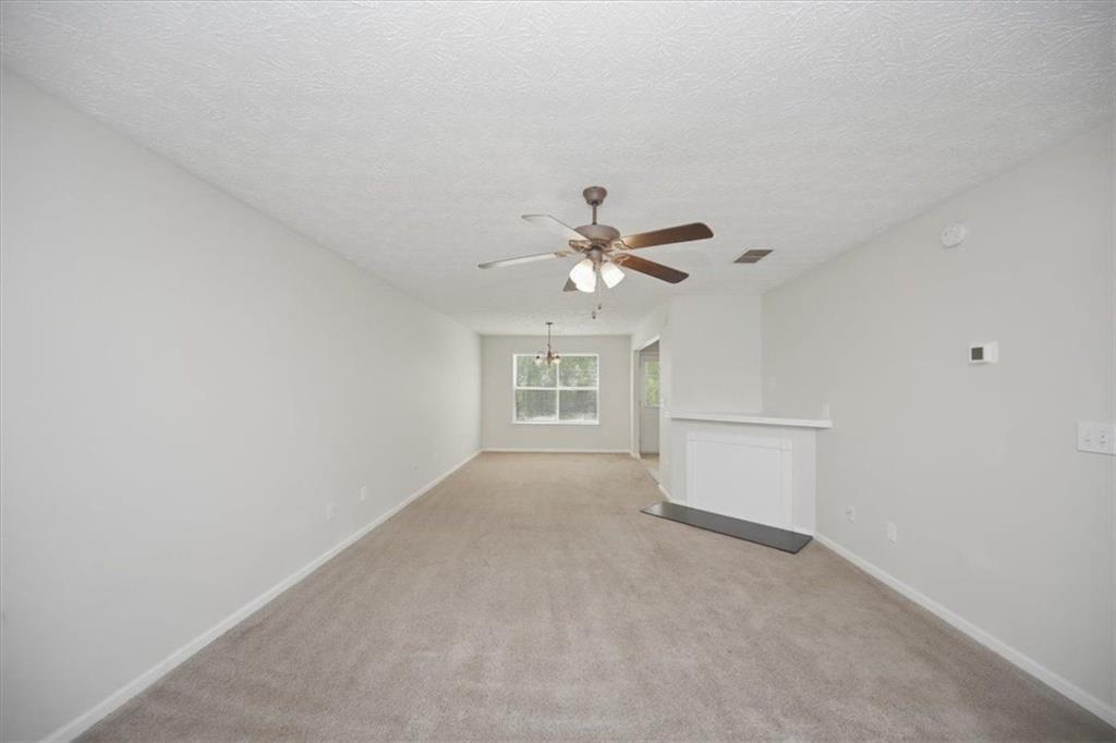 100 Wexford Way Covington, GA 30014 - Photo 7 of 37 a view of a room with a ceiling fan and a ceiling fan