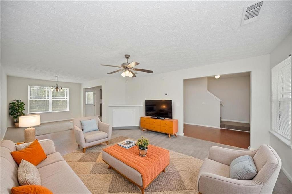 100 Wexford Way Covington, GA 30014 - Photo 8 of 37 a living room with furniture and a flat screen tv