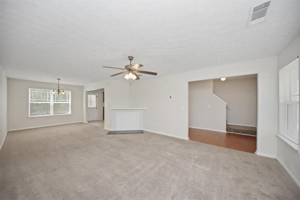 100 Wexford Way Covington, GA 30014 - Photo 9 of 37 an empty room with windows and fan