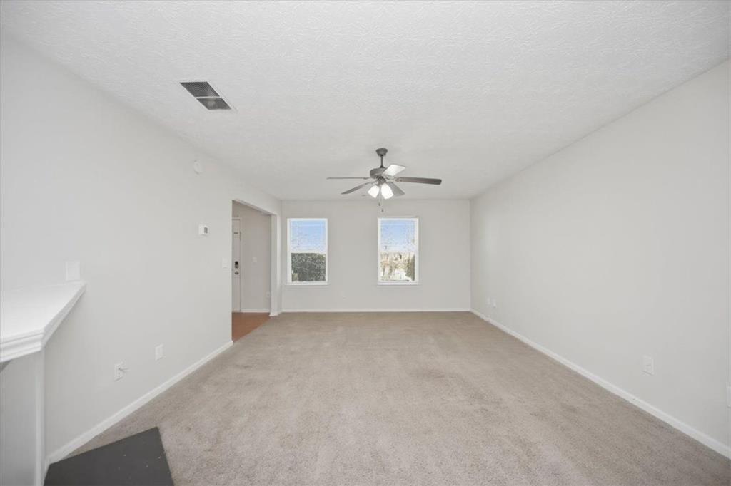 100 Wexford Way Covington, GA 30014 - Photo 10 of 37 an empty room with a window and a ceiling fan