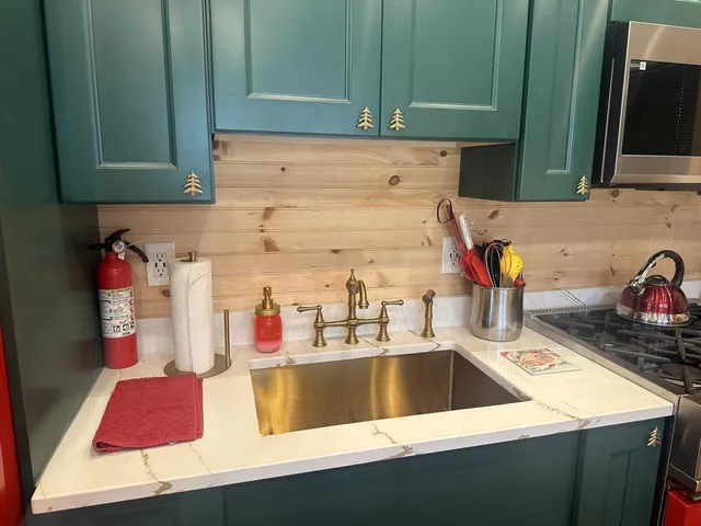 a kitchen with a sink and a stove top oven