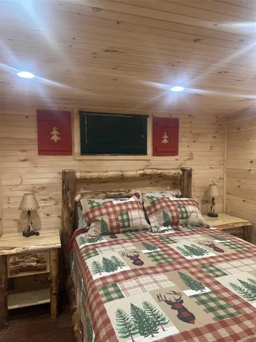 a bedroom with a bed and a tv