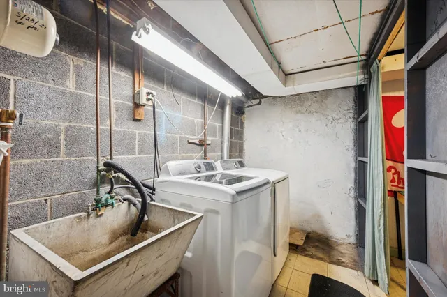 a kitchen with a sink a refrigerator and cabinets