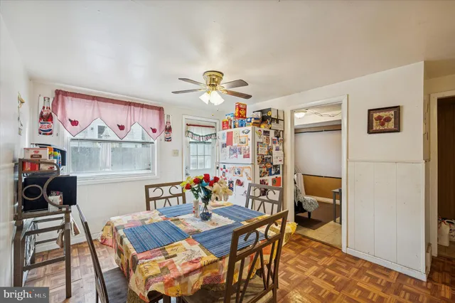 a view of a dining room with furniture and a chandelier