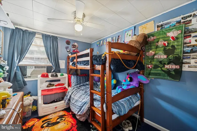 a bedroom with baby crib and a wooden floors
