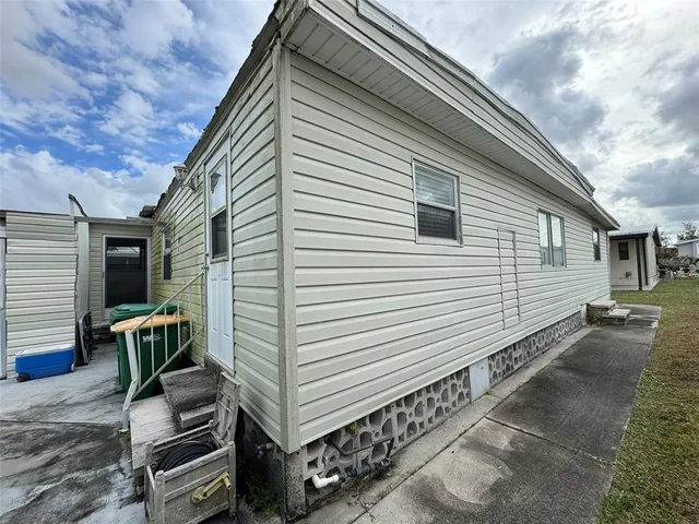 a view of a house with a yard and furniture
