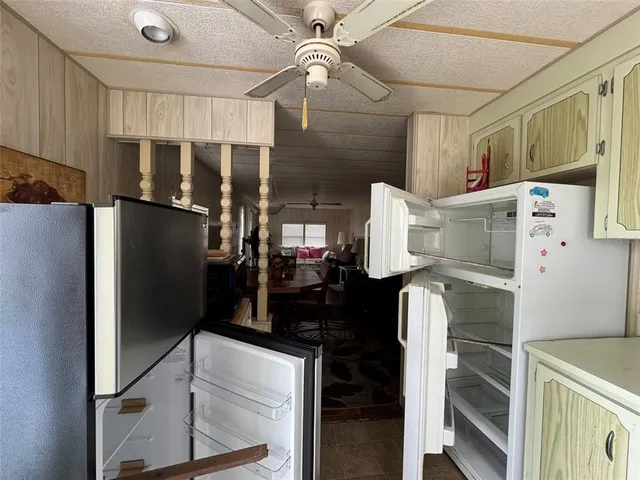 a kitchen with a refrigerator and a refrigerator
