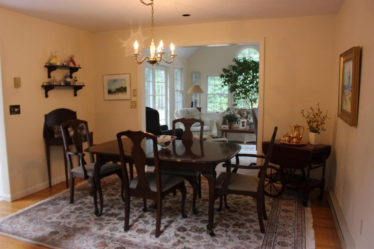 40 Lighthouse Lane Eastham, MA 02642 - Photo 11 of 33 a view of a dining room with furniture and chandelier