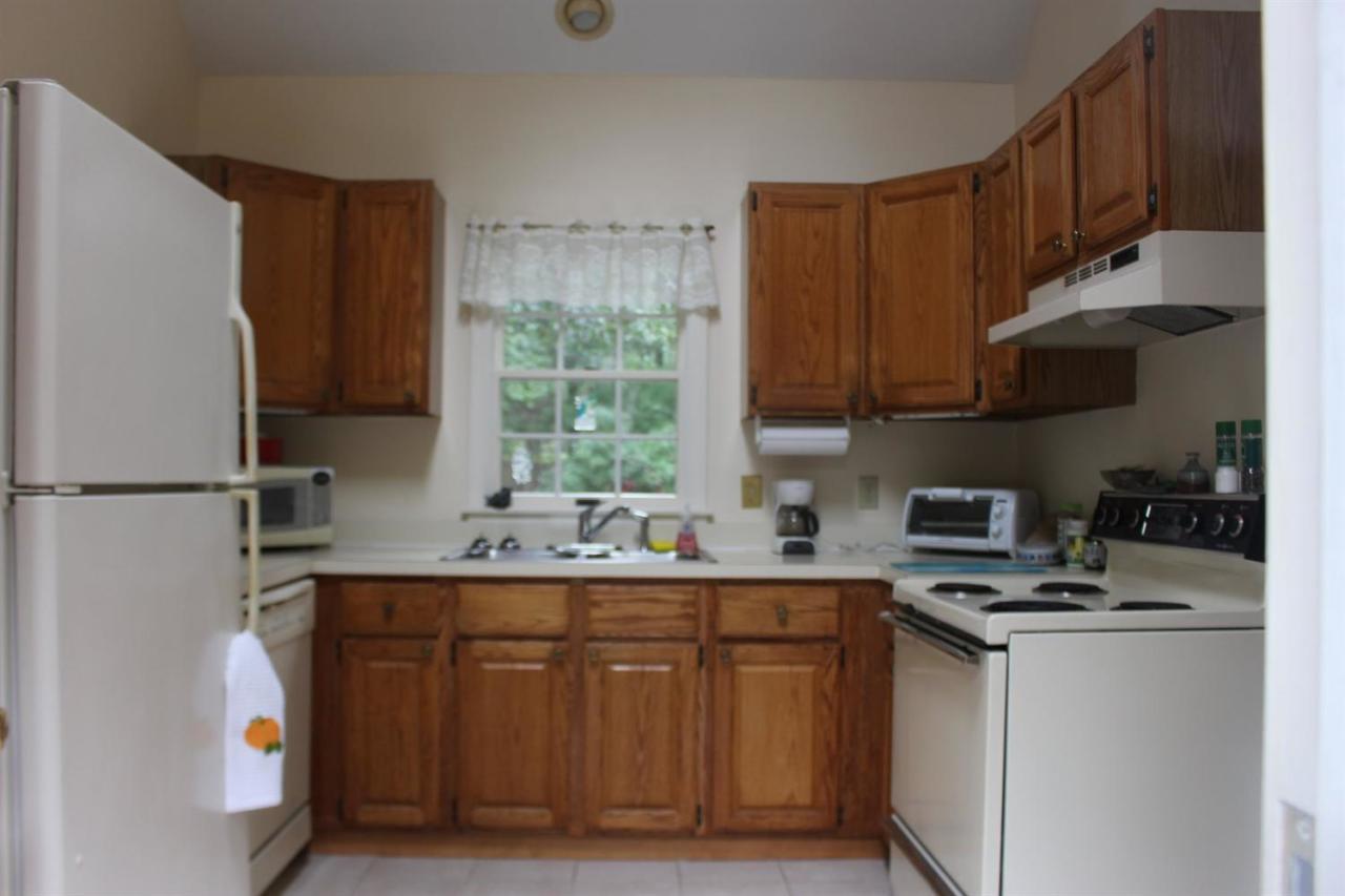 40 Lighthouse Lane Eastham, MA 02642 - Photo 13 of 33 a kitchen with a sink a stove and cabinets