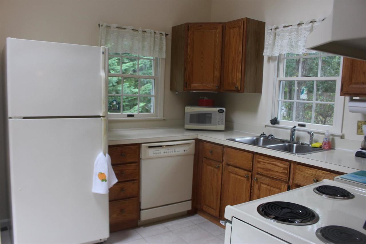 40 Lighthouse Lane Eastham, MA 02642 - Photo 14 of 33 a kitchen with stainless steel appliances a sink a refrigerator and a sink