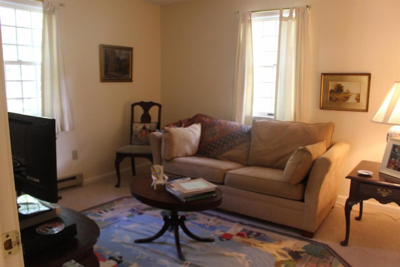 40 Lighthouse Lane Eastham, MA 02642 - Photo 15 of 33 a living room with furniture a flat screen tv and a window