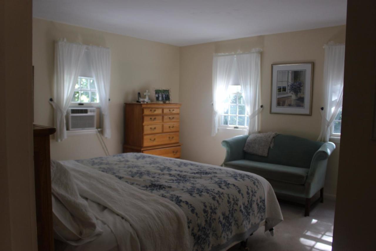40 Lighthouse Lane Eastham, MA 02642 - Photo 16 of 33 a bedroom with a bed and a couch