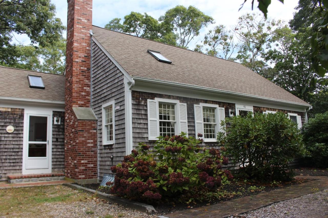 40 Lighthouse Lane Eastham, MA 02642 - Photo 2 of 33 a front view of a house with garden