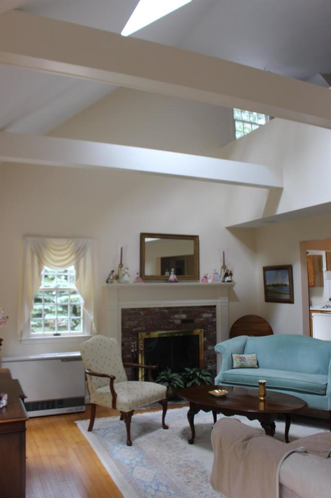 40 Lighthouse Lane Eastham, MA 02642 - Photo 22 of 33 a living room with furniture and a fireplace