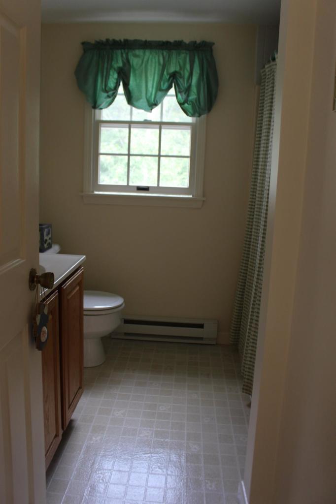 40 Lighthouse Lane Eastham, MA 02642 - Photo 23 of 33 a bathroom with a toilet a sink and a window