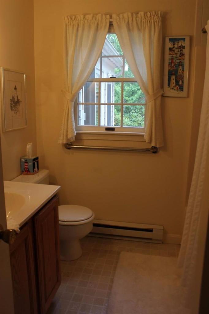 40 Lighthouse Lane Eastham, MA 02642 - Photo 24 of 33 a bathroom with a sink toilet and window