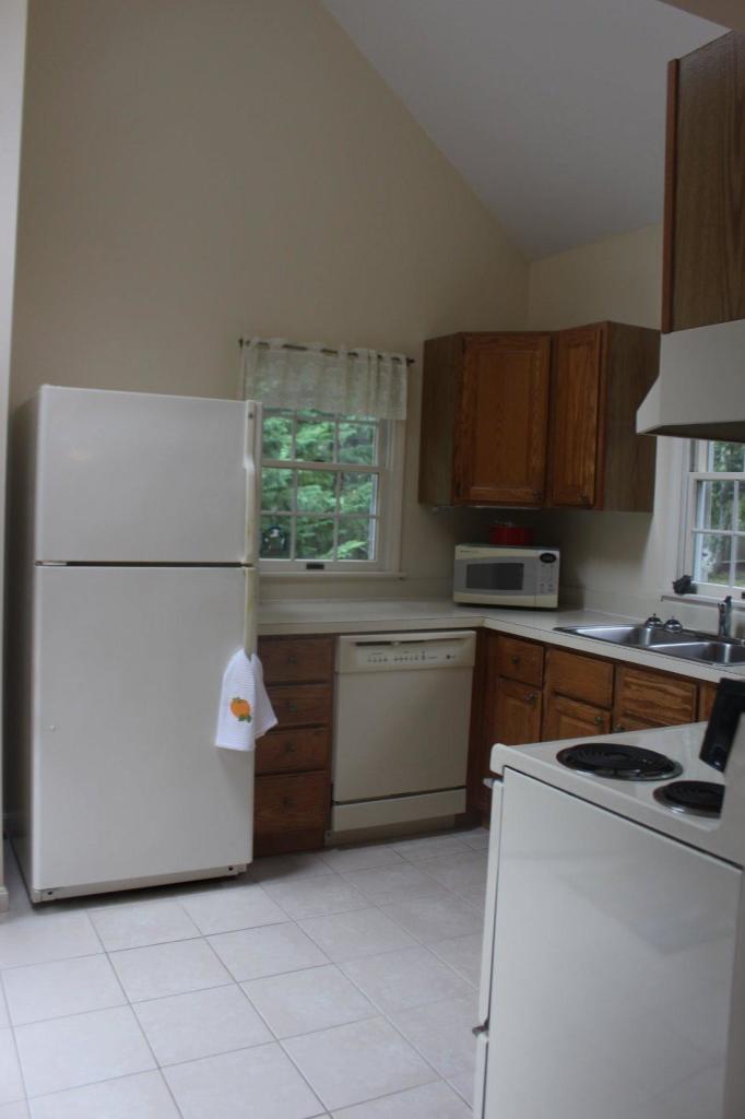 40 Lighthouse Lane Eastham, MA 02642 - Photo 25 of 33 a kitchen with stainless steel appliances a refrigerator sink and cabinets