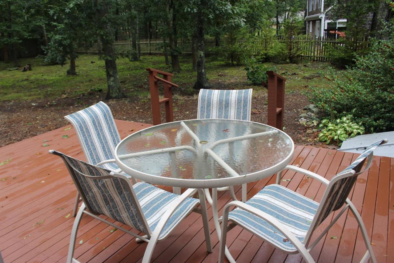 40 Lighthouse Lane Eastham, MA 02642 - Photo 27 of 33 a view of a chairs and table in backyard