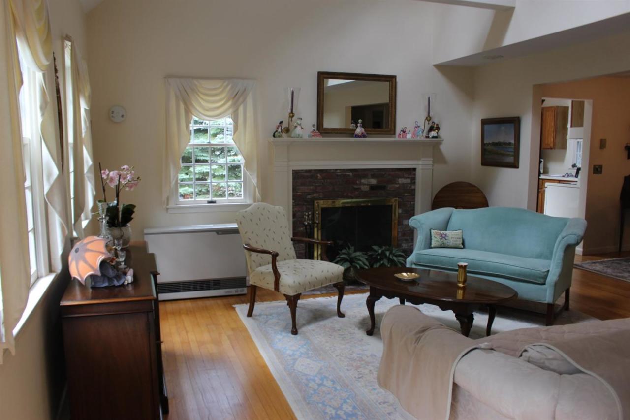 40 Lighthouse Lane Eastham, MA 02642 - Photo 5 of 33 a living room with furniture and a fireplace