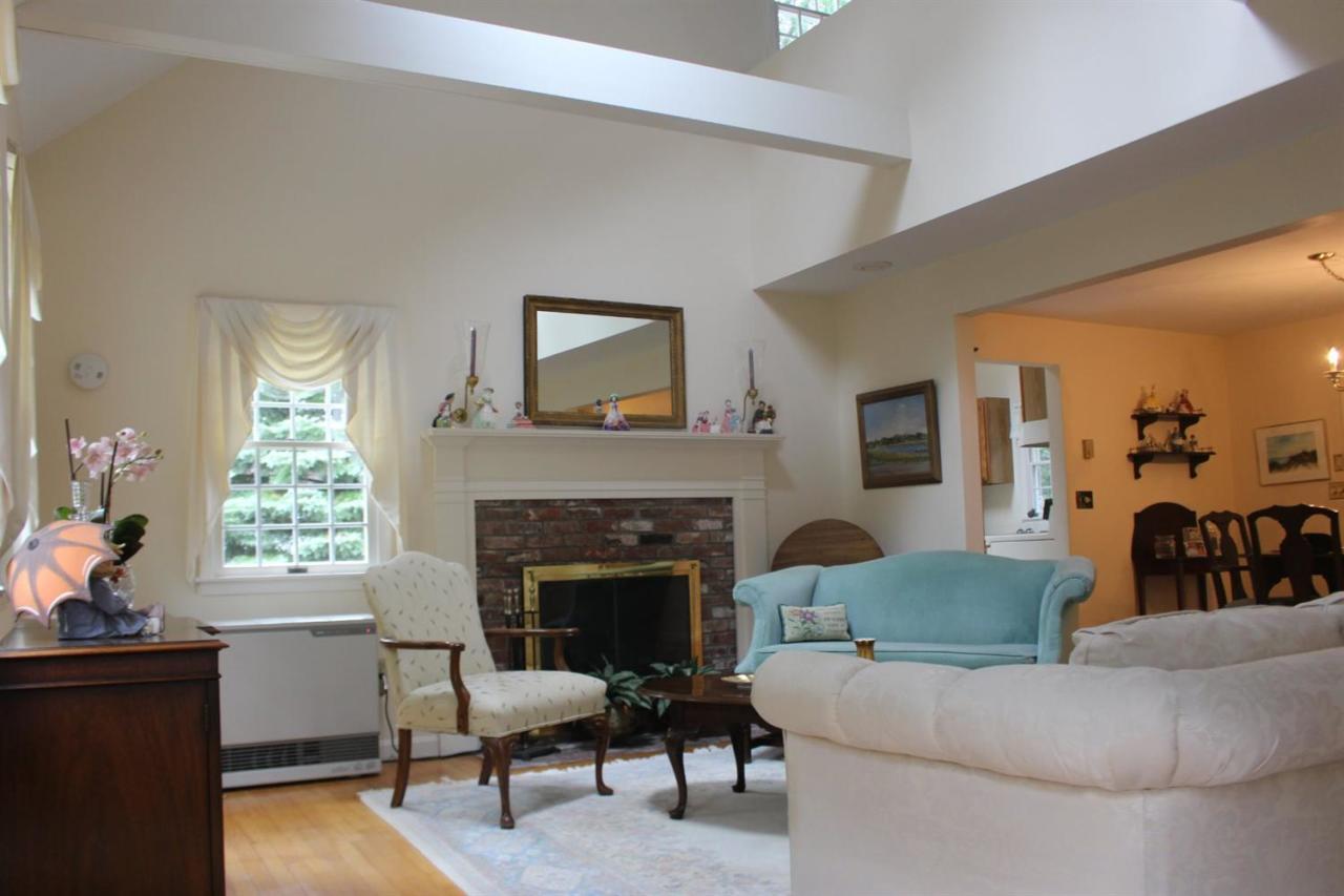 40 Lighthouse Lane Eastham, MA 02642 - Photo 8 of 33 a living room with furniture and a fireplace