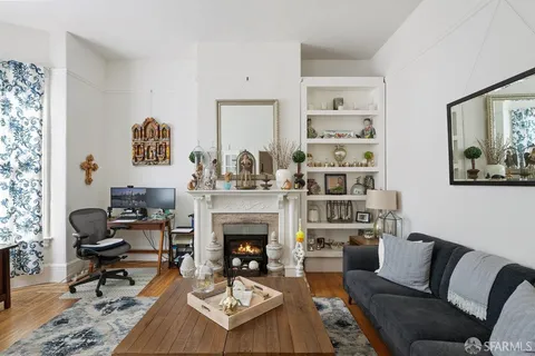 a living room with furniture fireplace and rug