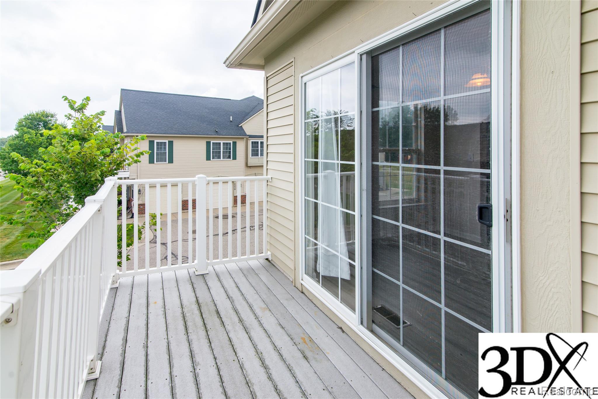 4256 Hampton Ridge Boulevard Howell, MI 48843 - Photo 16 of 25 Exterior balcony featuring composite decking, white railing, and a sliding glass door with an integrated screen