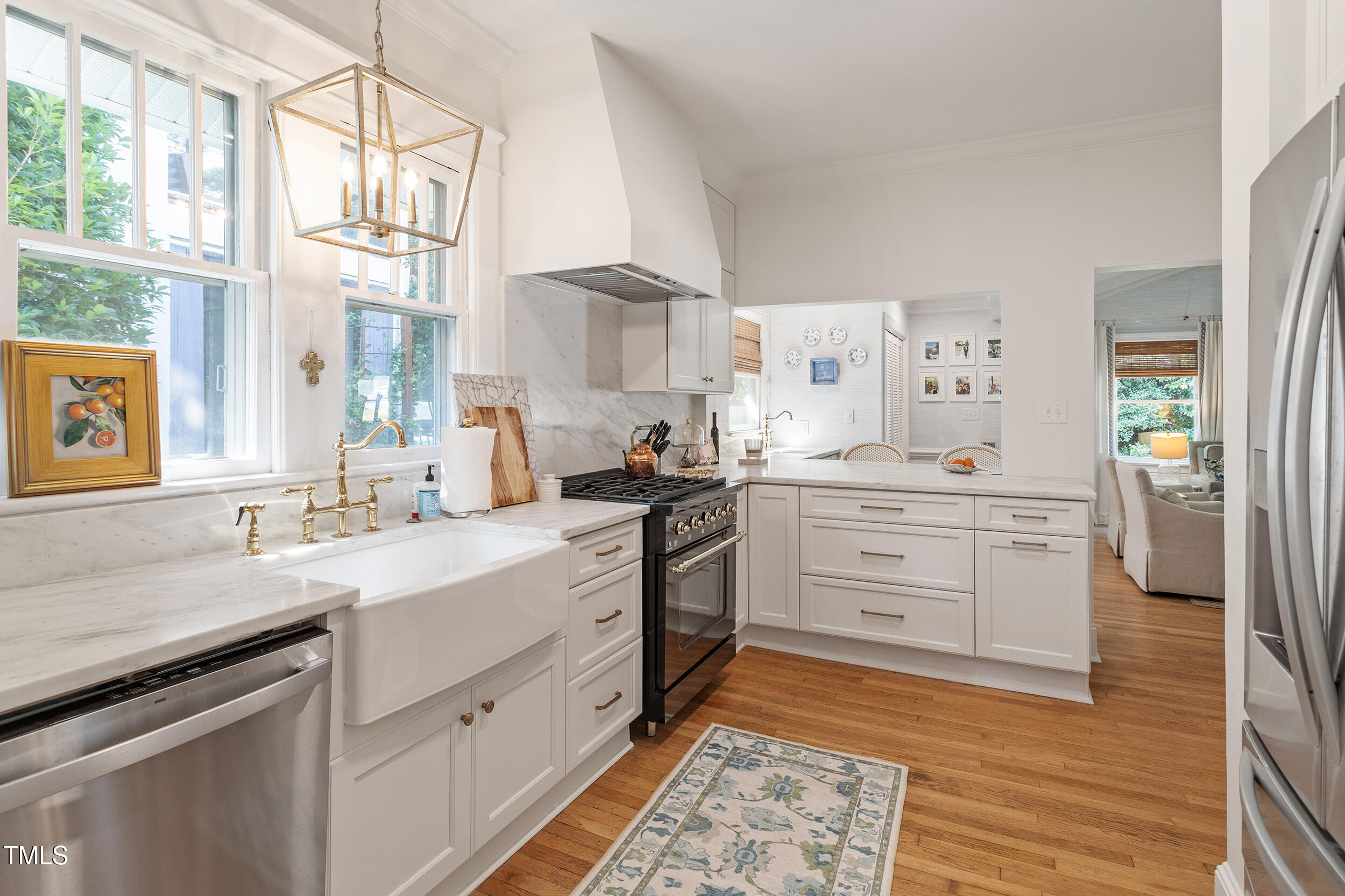 2225 Creston Road Raleigh, NC 27608 - Photo 16 of 27 a kitchen with cabinets appliances and a window