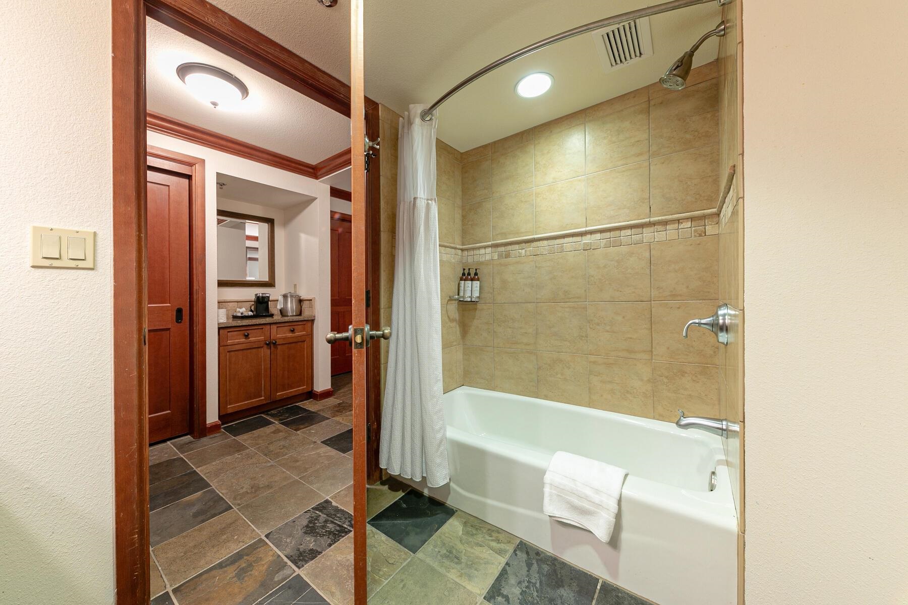 400 Resort Road, Unit 317 319 Olympic Valley, CA 96146 - Photo 13 of 25 a bathroom with a tub shower vanity and a sink