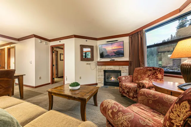 a living room with furniture a fireplace and a flat screen tv