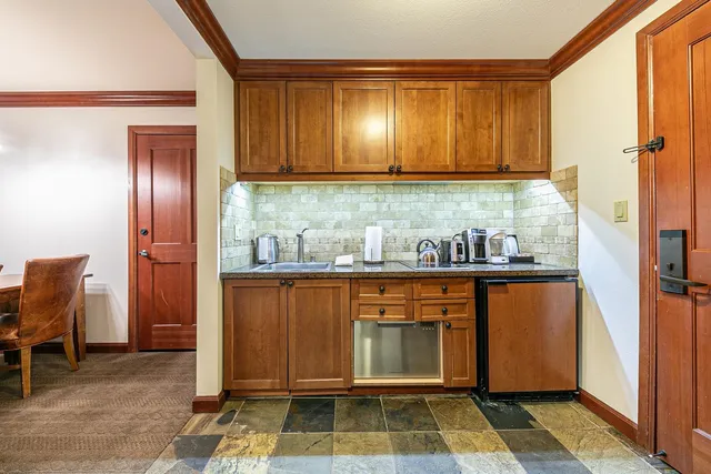 a room with granite countertop stainless steel appliances a sink and cabinets