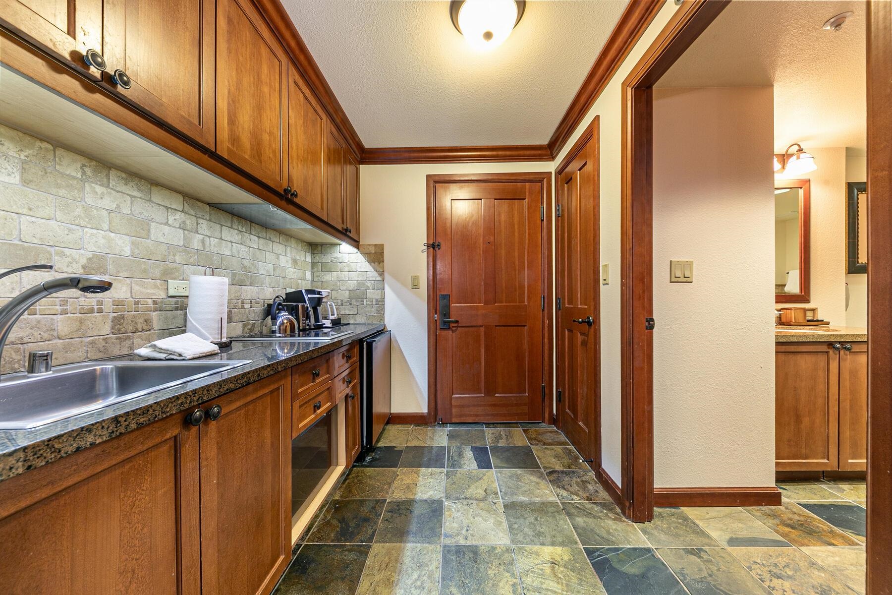 400 Resort Road, Unit 317 319 Olympic Valley, CA 96146 - Photo 6 of 25 a kitchen with granite countertop a sink and cabinets