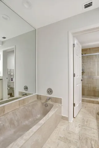 a bathroom with a tub sink and shower