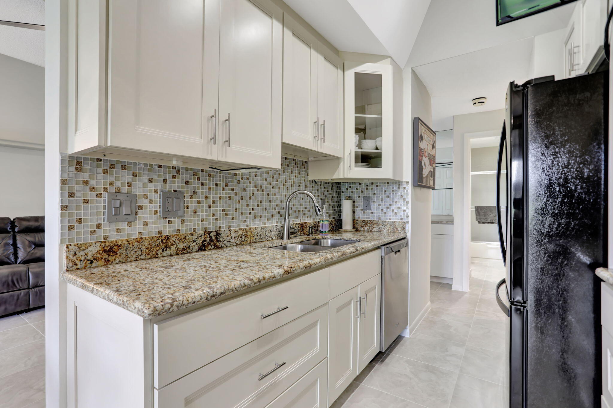 7460 La Paz Boulevard, Unit 108 Boca Raton, FL 33433 - Photo 10 of 40 a kitchen with granite countertop a sink stove and refrigerator
