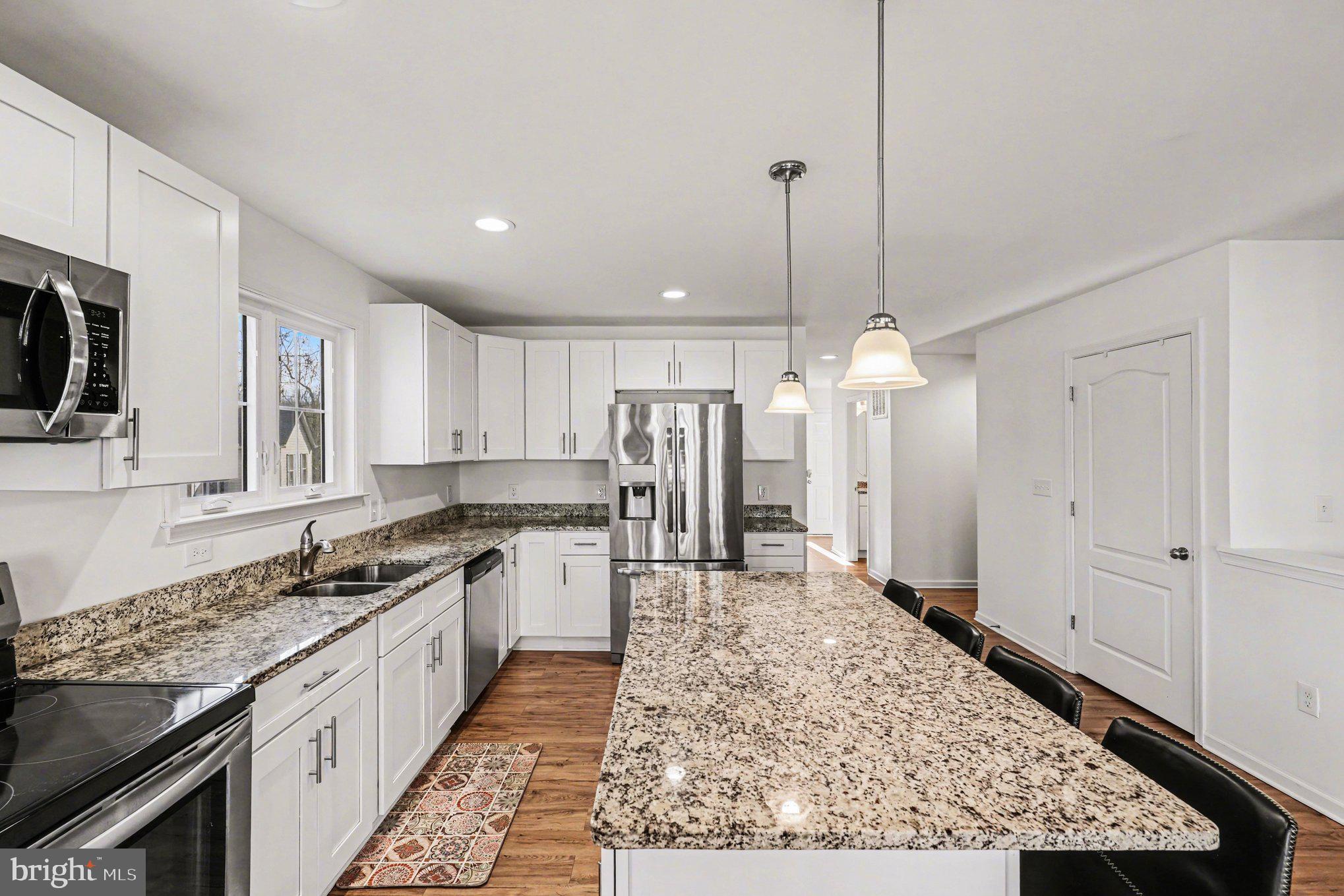 117 Butler Circle Locust Grove, VA 22508 - Photo 11 of 35 a kitchen with stainless steel appliances granite countertop a sink refrigerator and cabinets